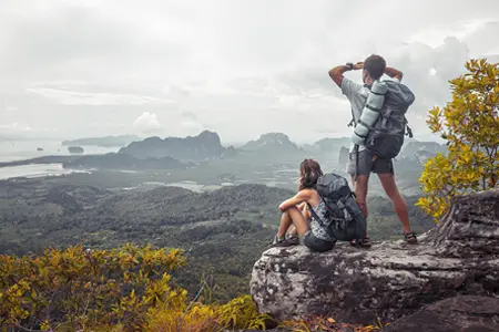 Travelers looking into the distance from the cliffs